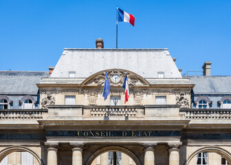 Obraz premium Paris, France - June 17, 2026: Front view of the portico of the Council of State, a public body created in 1799 by Napoleon, decked with french and European Union flags, located in the Palais Royal.
