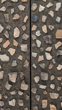 Jomon period pottery shards textured wall background, ancient earthenware fragments arranged as geometric pattern, design material for architectural and interior decoration