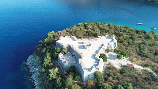 Cinematic aerial view of the historic Ali Pasha Castle on Porto Palermo peninsula surrounded by the Mediterranean Sea, Albania