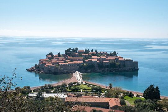 Aerial view of Sveti Stefan island, a popular tourist destination in Montenegro, showcasing its historic buildings and beautiful coastal scenery.