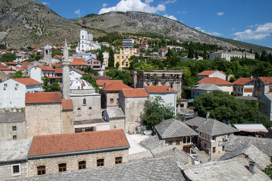 historic town of Mostar in Bosnia and Herzegovina, featuring the Karadoz Bey Mosque and the Franciscan Church tower, captured from the minaret of the Koski Mehmed Pasha Mosque.