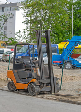 Small Orange Forklift Tuck Vehicle at Outdoor Parking