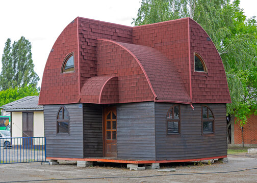 Prefabricated House Dwelling With Gambrel Style Arch Roof Red Shingle Grey Woden Siding