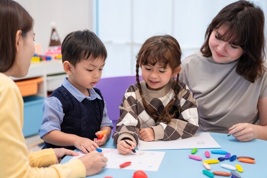 Children and adults create art together in a classroom setting during an art activity in the morning