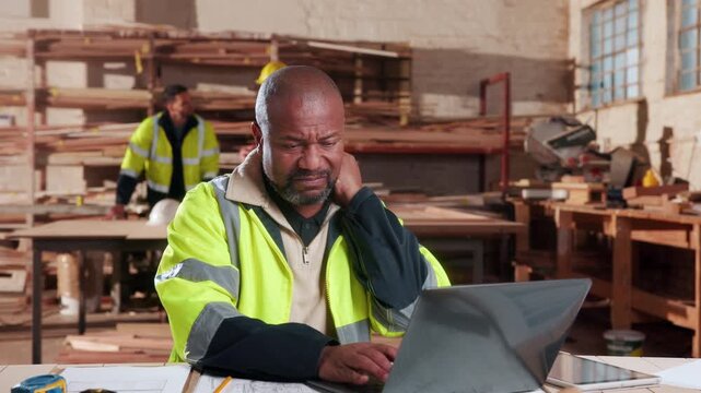 Carpentry, neck pain or man in workshop with laptop, burnout or joint strain with muscle injury. Tendinitis, bad posture or mature artisan with tech, discomfort or fatigue in cervical sprain.