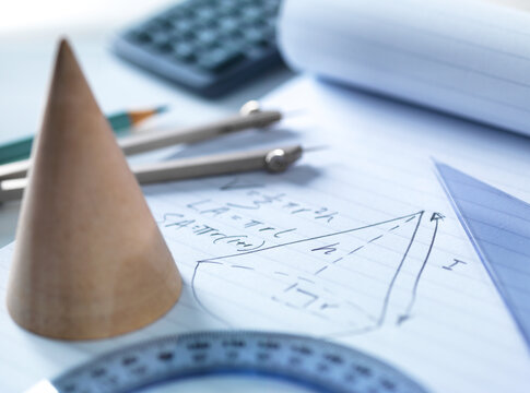 Close-up of mathematical instruments with diagram on table