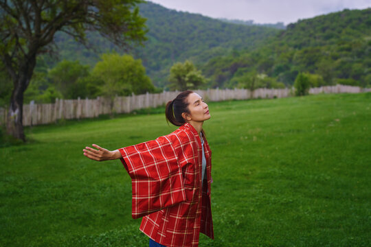 Woman enjoying nature breathing fresh air in the countryside