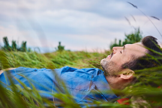 Relaxed man lying in grass