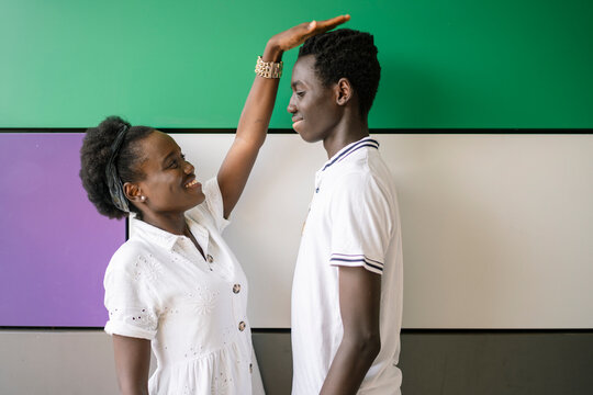 Small young woman and tall teenage boy