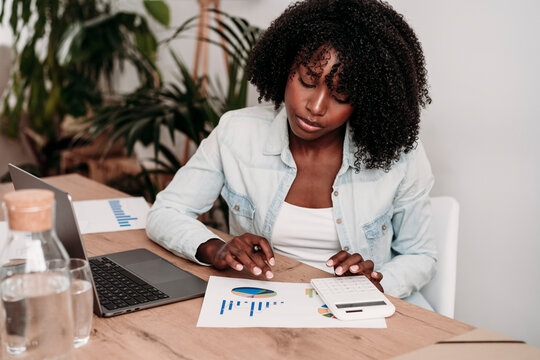 Businesswoman preparing data sitting at desk in home office