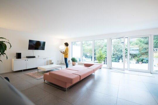 Woman using laptop in a spacious living room at home
