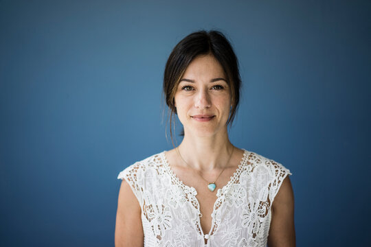 Portrait of a beautiful woman against blue background
