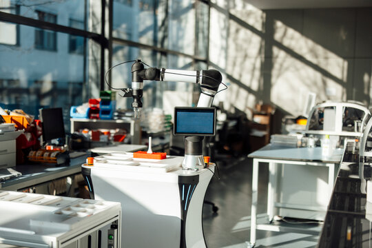 Automated robotic arm inside a modern medical research laboratory