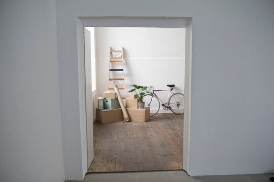 Moving house, view through door of cardboard boxes and ladder