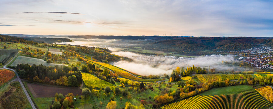 Germany, Baden Wurttemberg, Remstal, Drone view of countryside town at foggy sunrise