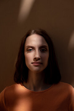 Young woman staring in front of wall