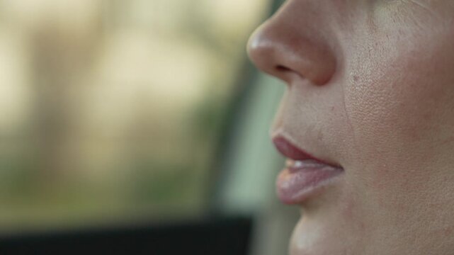 Makeup removal lips woman cleaning lipstick from her mouth with a white tissue inside a car