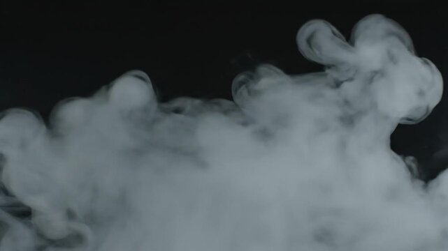 White smoke swirls gracefully against a deep black background