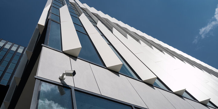 Futuristic facade of a modern office building with security camera from low angle view