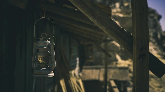 Sad lantern beside collapsed veranda with distant rocks. Somber lantern against dilapidated veranda with distant boulders and nostalgic atmosphere