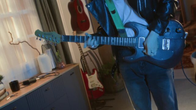 Young guitarist playing electric guitar and headbanging at home. Footage for youth lifestyle commercials, music education promos, or creative hobby advertisements