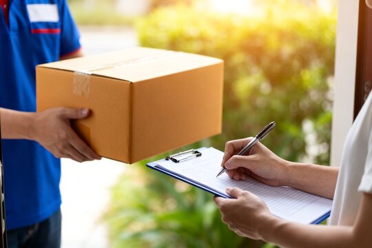 Delivery person handing box to recipient