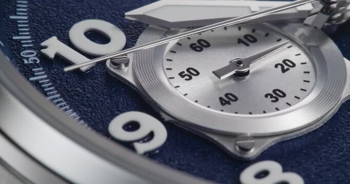 Macro close up of luxury watch dial with blue textured face and chronograph subdial