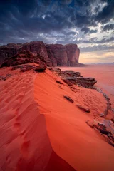 Fototapete Rot Vertical photo Wadi Rum desert landscape with sand dunes and majestic mountains at sunset, Jordan.  © Tomasz