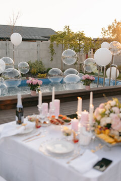 Outdoor birthday dinner party by swimming pool