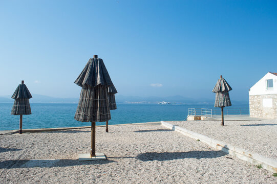 Traditional Straw Beach Umbrellas at Kolovare Beach in Zadar, Croatia