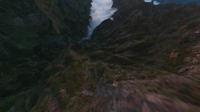 FPV Drone Dive Through Mountain Gap Into Sea of Clouds