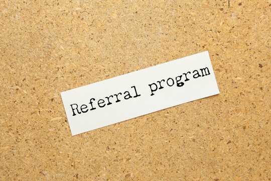 referral program text on torn paper