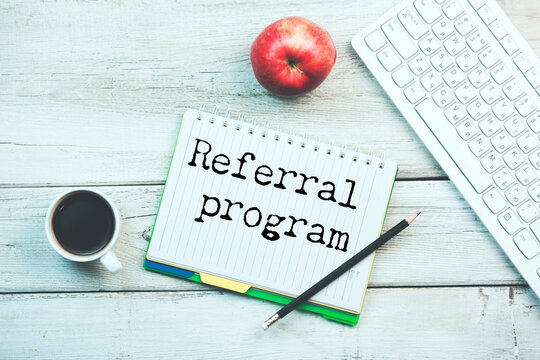 referral program text on torn paper