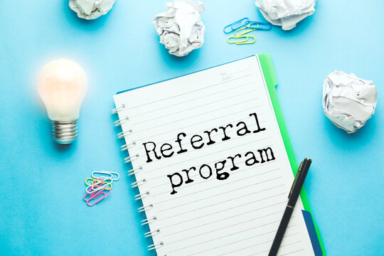 referral program text on torn paper