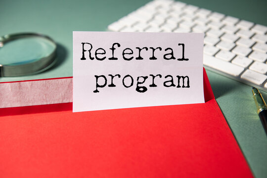 referral program text on torn paper