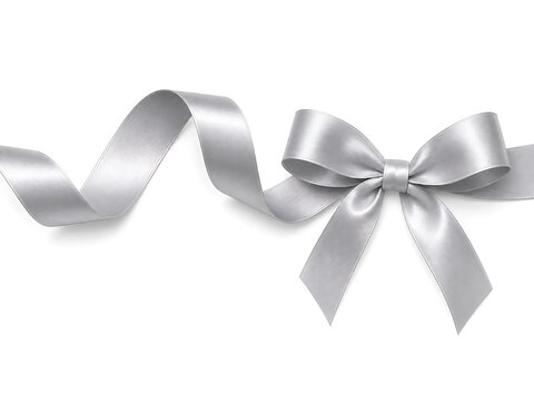 A silver ribbon tied into a bow with loose ends on a background with copy space