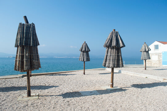 Traditional Straw Beach Umbrellas at Kolovare Beach in Zadar, Croatia