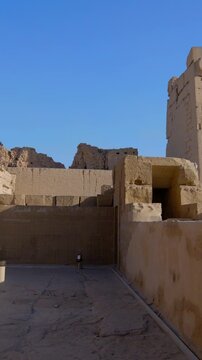 Kom Ombo temple ruins with double columns and composite capitals against clear blue sky in Egypt, ancient Ptolemaic architecture dedicated to Sobek and Horus with damaged walls