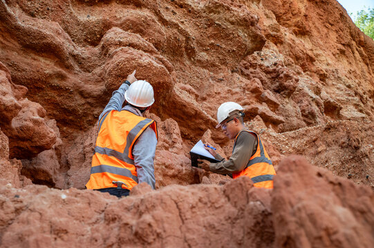 Geological Survey Team Examining Rock Layers for Mineral and Soil Investigation