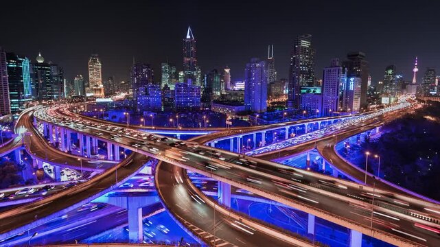 Zoom in pan up time lapse of busy elevated road intersection with commuters with neon lighting, at night, Asia, China, Shanghai