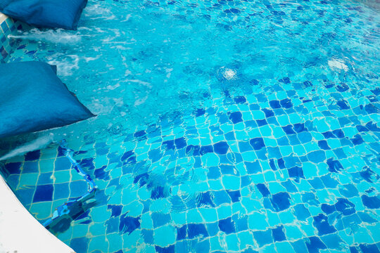 Empty swimming pool with sunbed and white umbrella in resort hotel for vacation leisure and white sand,resort neary sea and beach in summer.