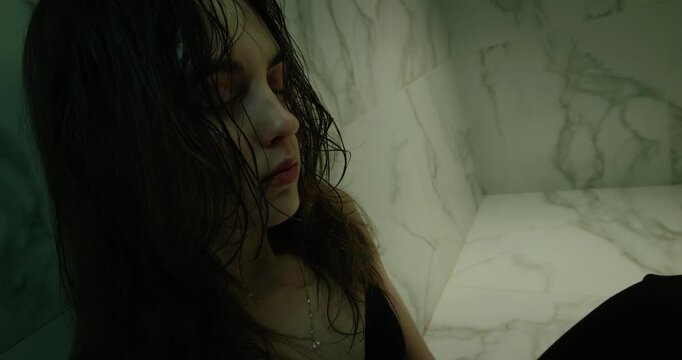 Sad woman sit floor dark bathroom. Female person depression feel loneliness stress. Emotional mental health crisis, grief concept. Drug addict problem. Alone girl suffer breakdown, inner struggle pain