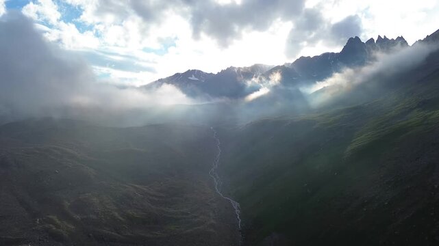 Moody Cinematic Flight Over Mist-Covered Mountain Valley