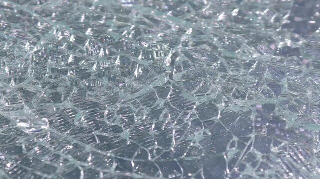 Slow Pan Across Shattered Tempered Safety Glass with Detailed Broken Glass Texture