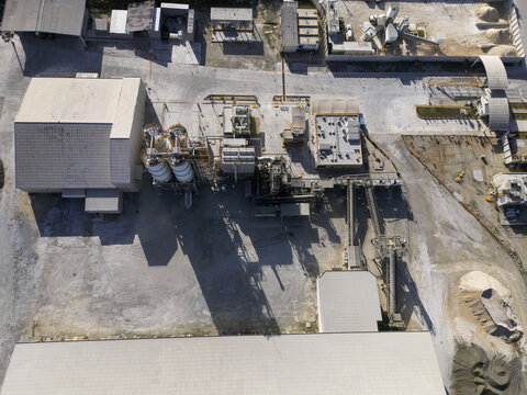 Aerial view of Ergon Asfaltos Progreso industrial facility featuring storage silos, processing units, and warehouses in Progreso, Yucatan, Mexico.