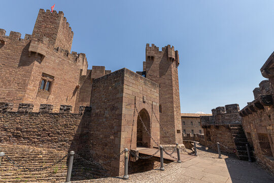 Javier, Spain. View of the stone drawbridge and inner defensive gateway of the Castle of Javier showing the tall Undues tower, the keep, crenellated walls and a dry moat on a sunny day