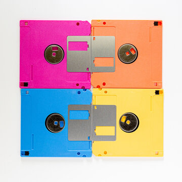 Four Colorful Floppy Disks in Grid Arrangement on White Background