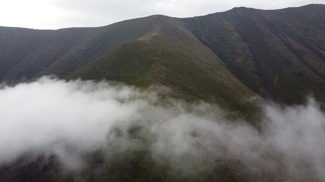 Drone footage of cloud inversion over mountain landscape