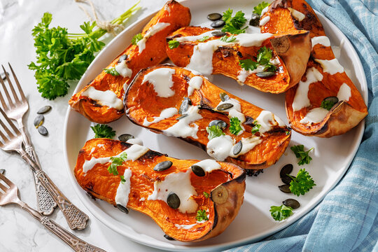 Baked butternut squash halves with yogurt sauce