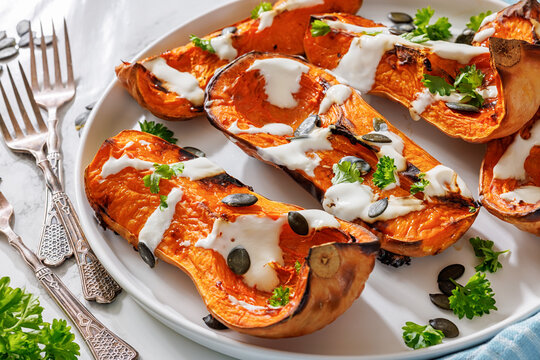 Baked butternut squash halves with yogurt sauce
